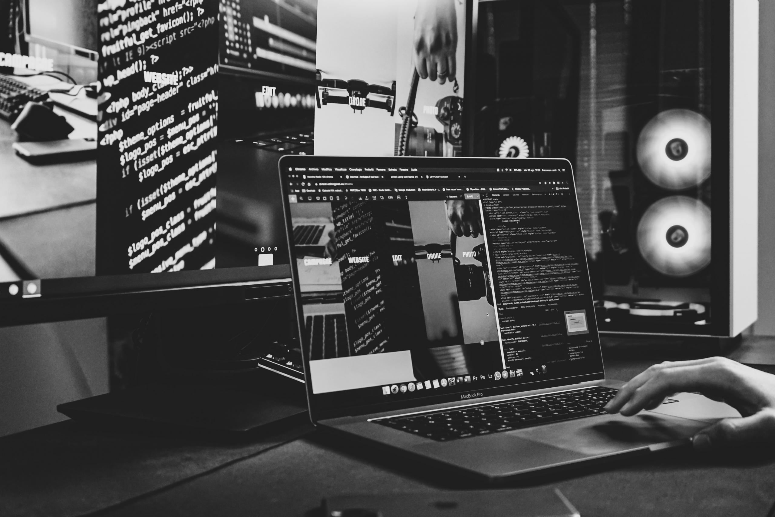 Black and silver laptop computer on black table