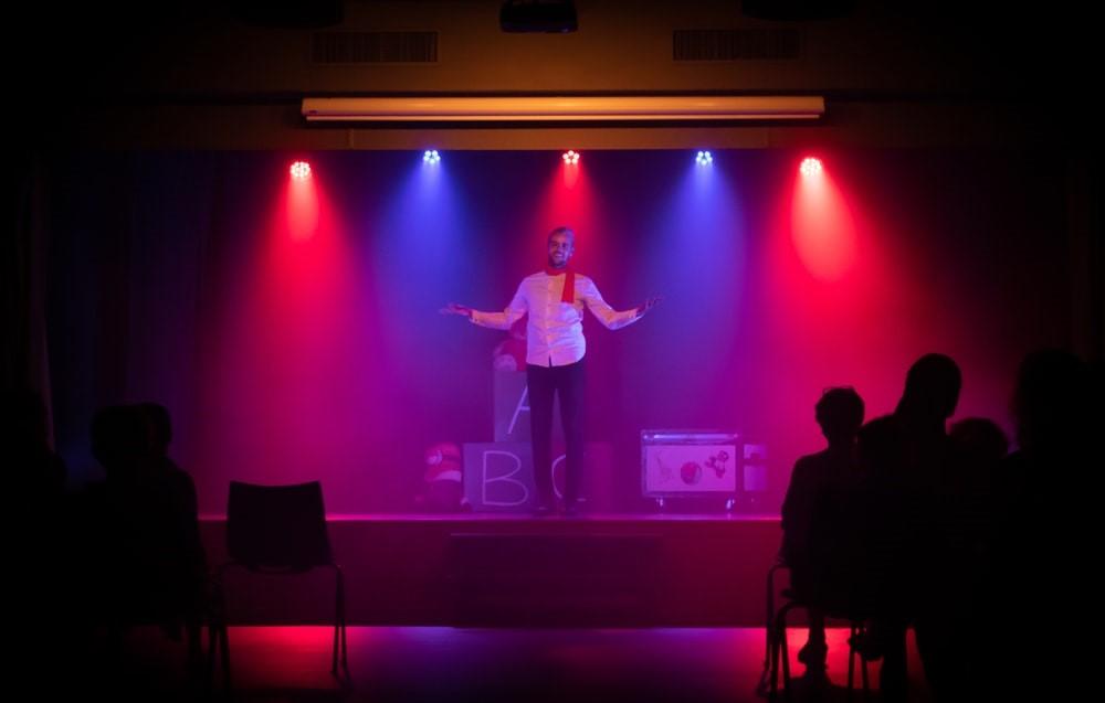 A man during a stand-up comedy act