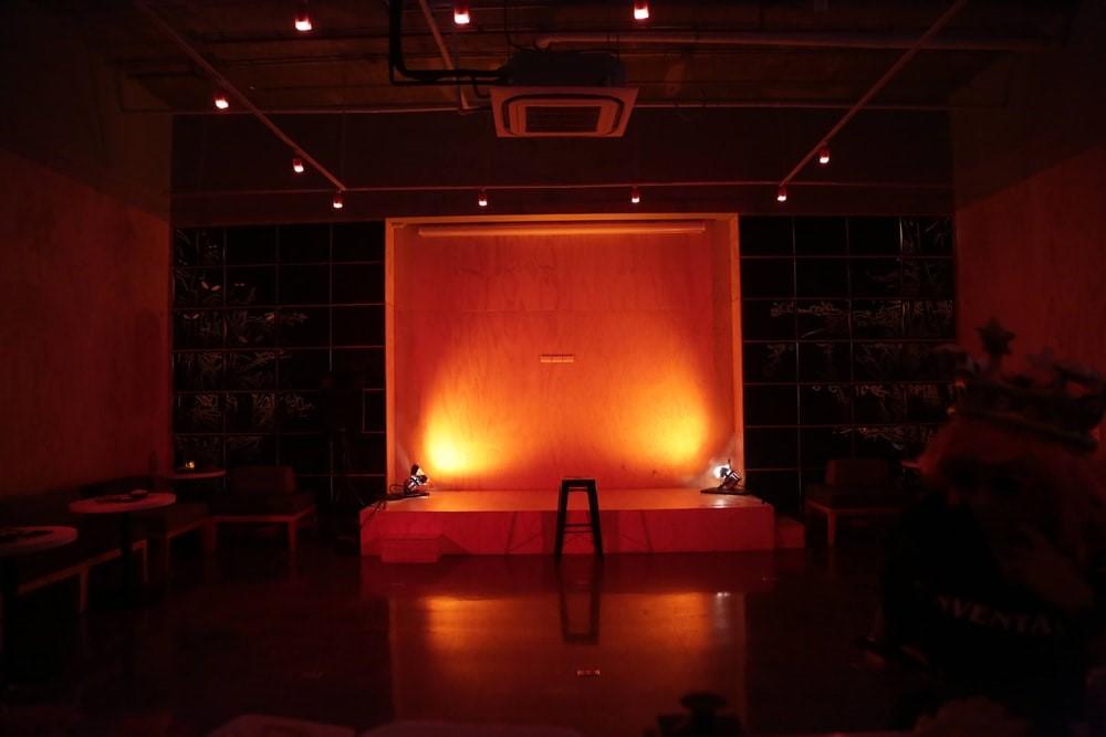 A stage set up for an open mic stand up comedy performance