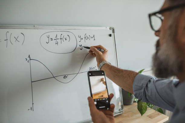 An online algebra tutor writing something on a whiteboard while teaching