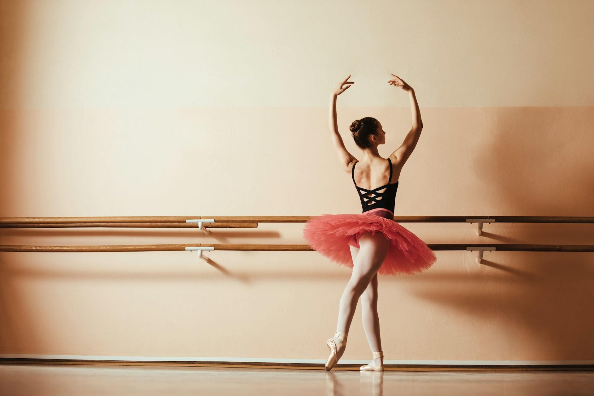 A ballerina posing at the bar