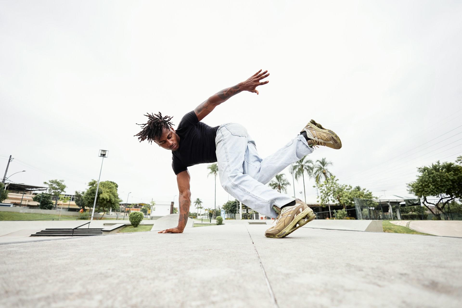 A man breakdancing at a park
