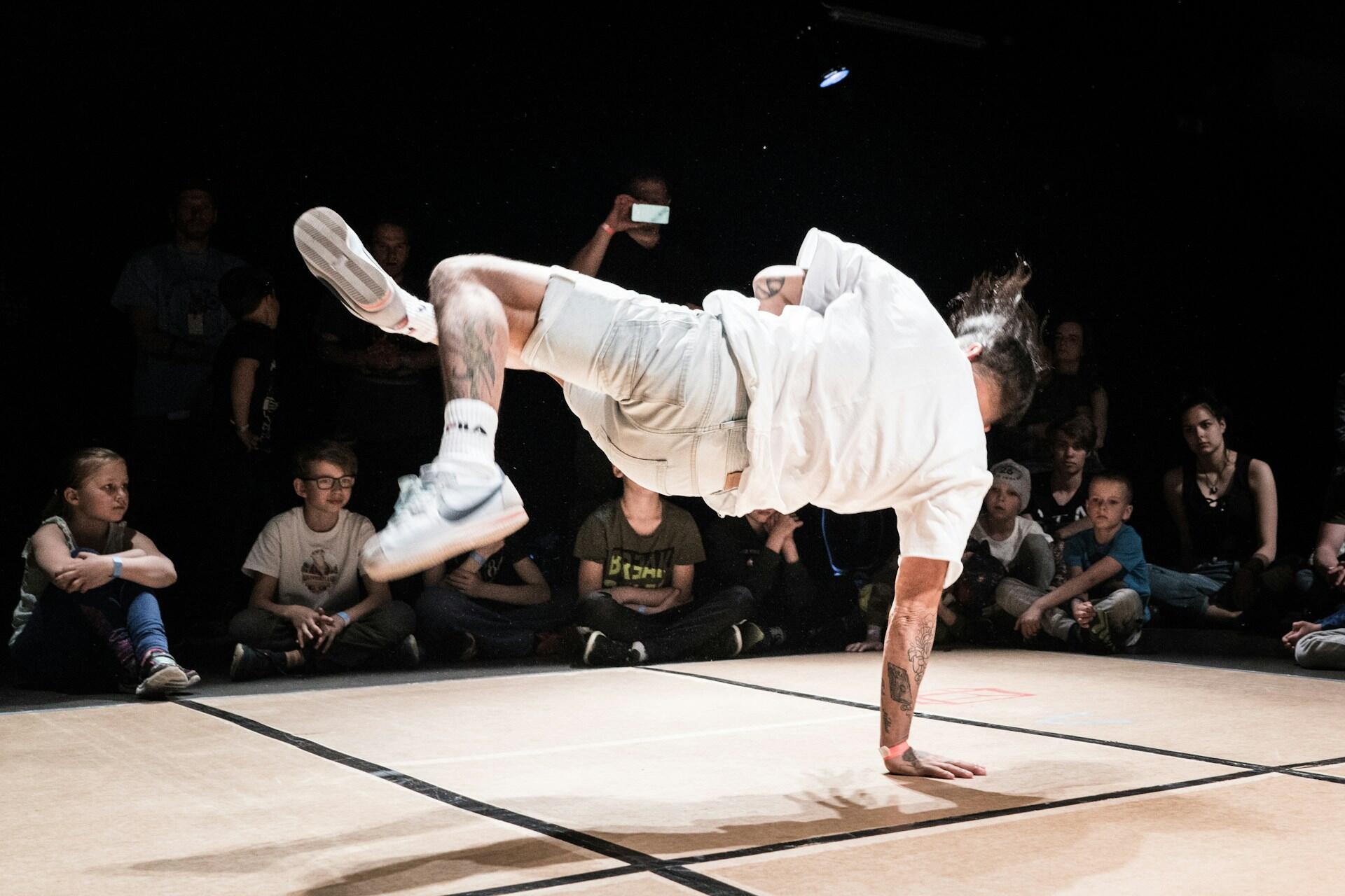 A breakdancer doing a hand plant.
