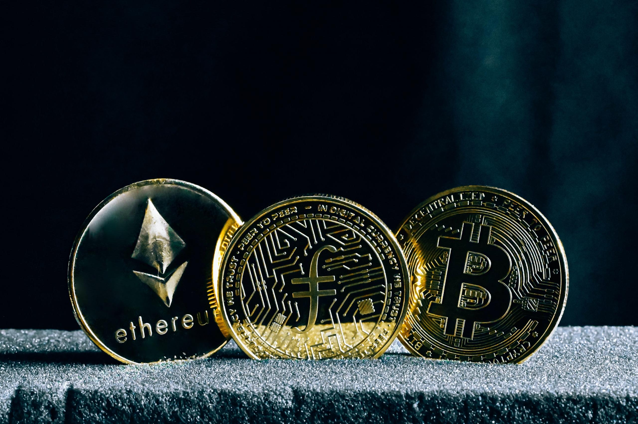 Three types of cryptocurrency (Ethereum, Flipcoin, and Bitcoin) placed together