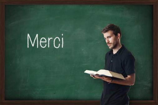 A French teacher standing in front of a board