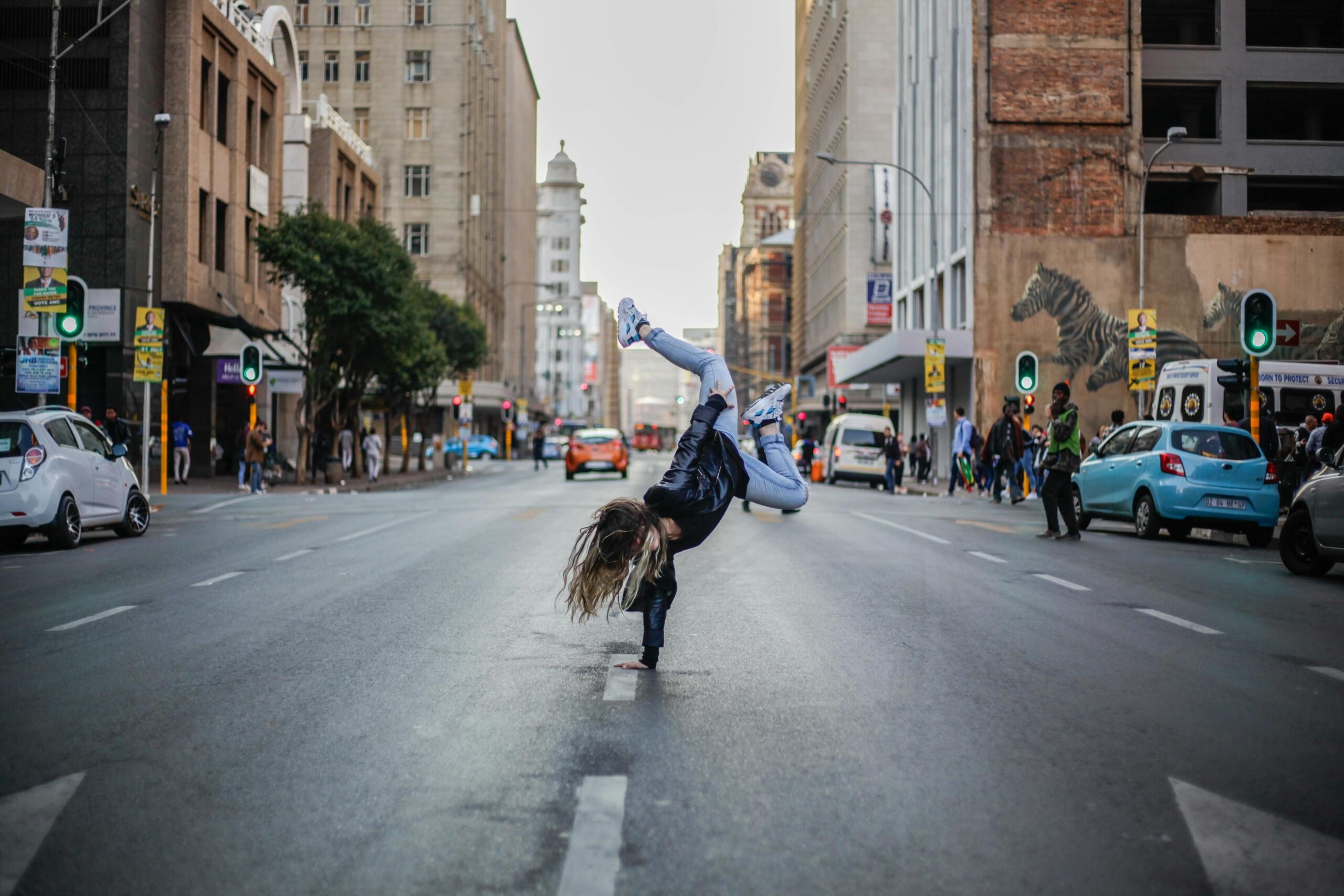 Woman breakdancing on street