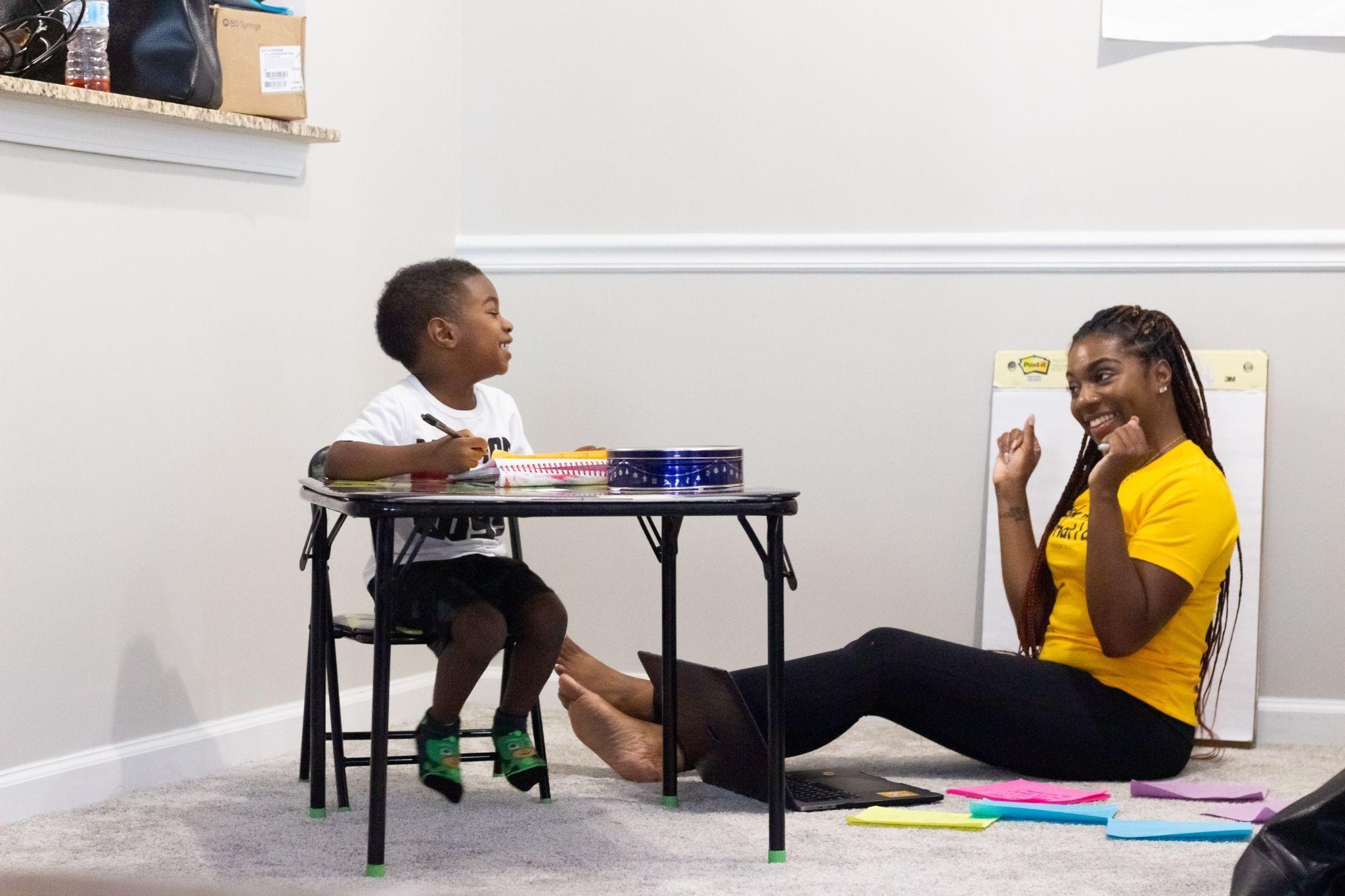 A home tutor giving a lesson to a child