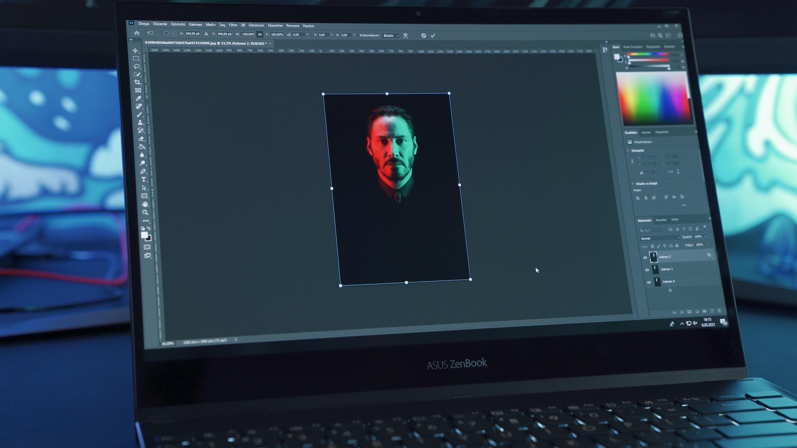 A graphic designer editing John Wick’s picture on Adobe Photoshop