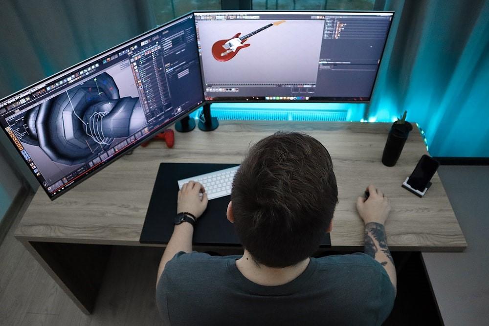 Man sitting in front of a computer and working on animations