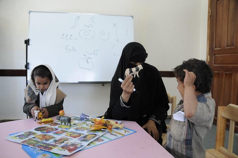 Students practice sign language with a teacher