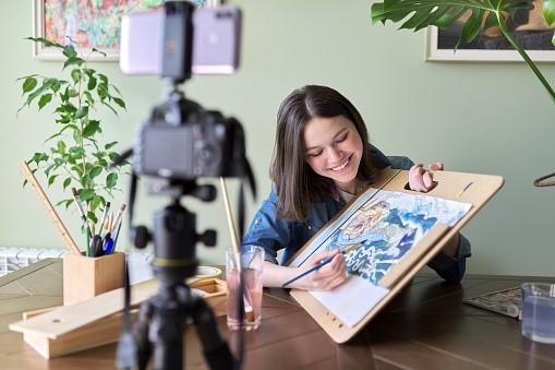 A teacher recording an online drawing lecture for her students