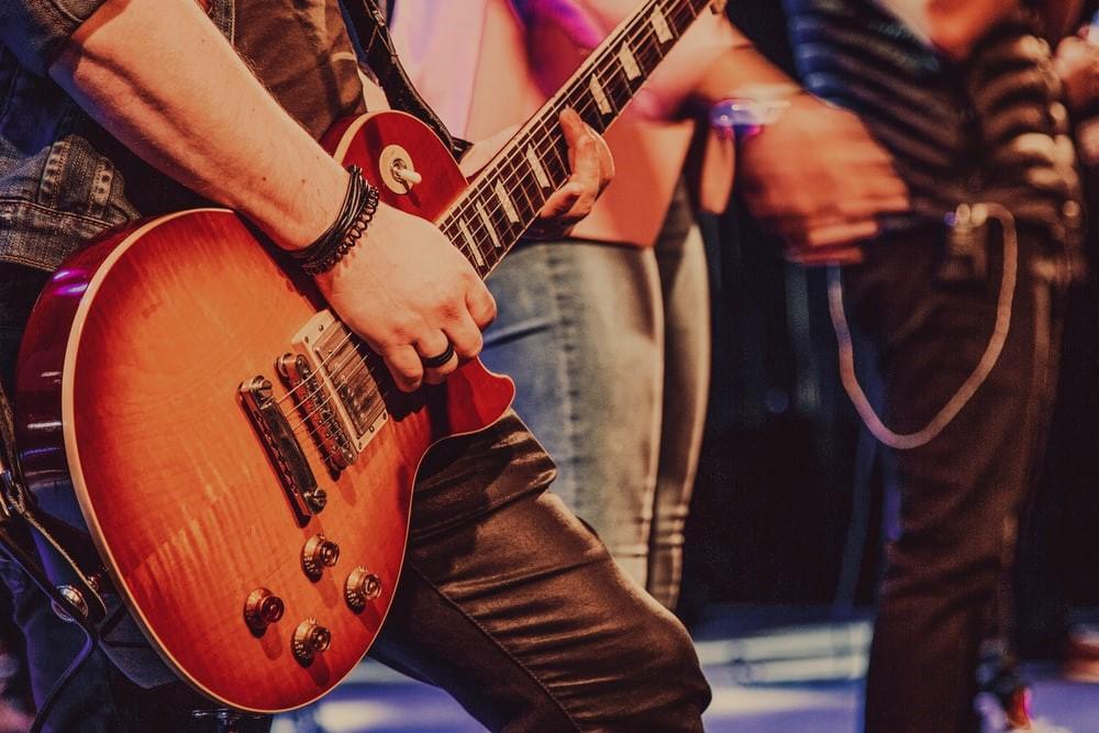 A man in black playing guitar