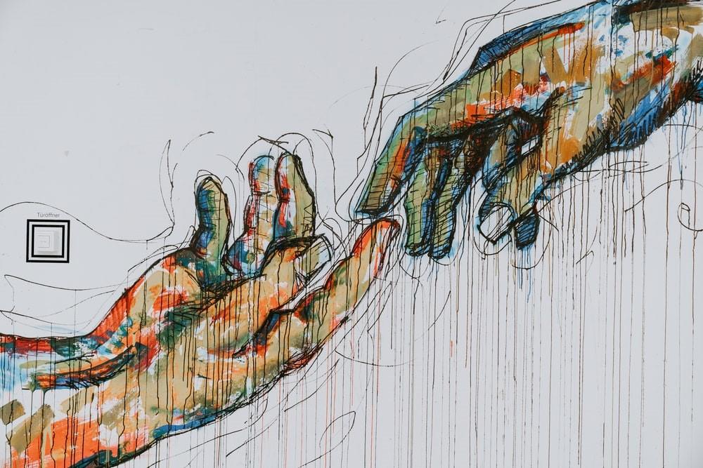 Two human hands painting