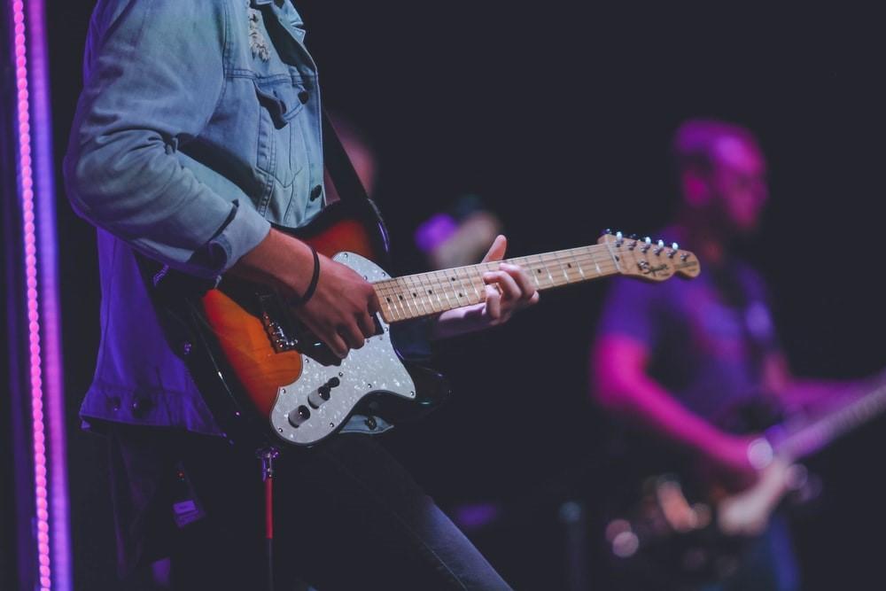 A man playing electric guitar on stage