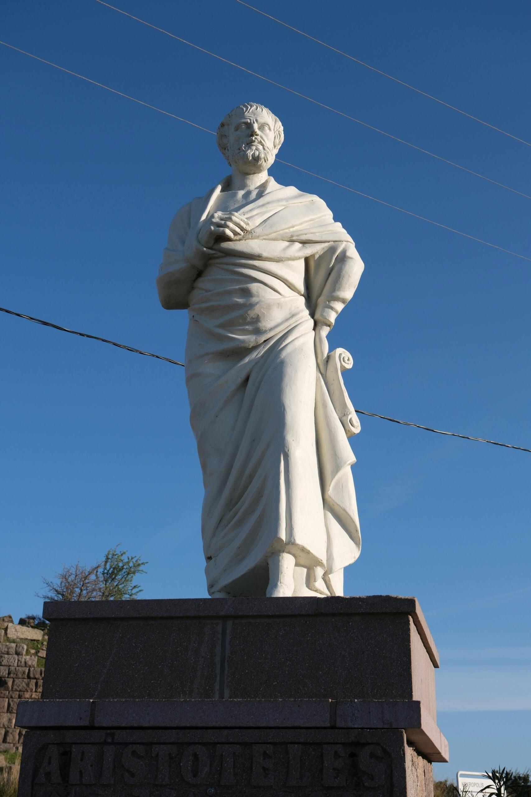 Statue of Aristotle standing outdoors in Behramkale, Turkey.