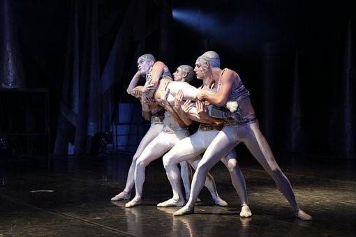 A group of people performing live at a theatre