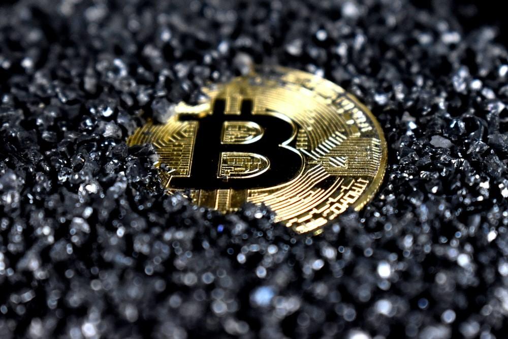A Bitcoin covered in black crystal