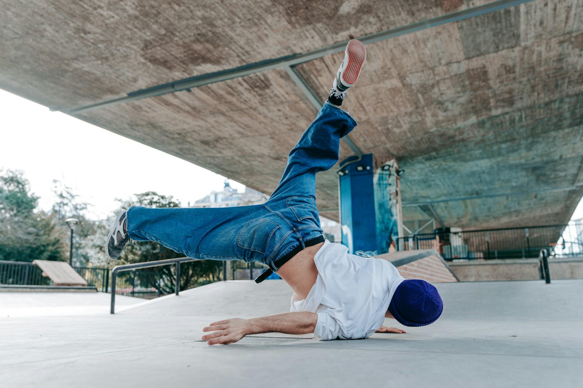 A hip hop dancer practicing at the skatepark.