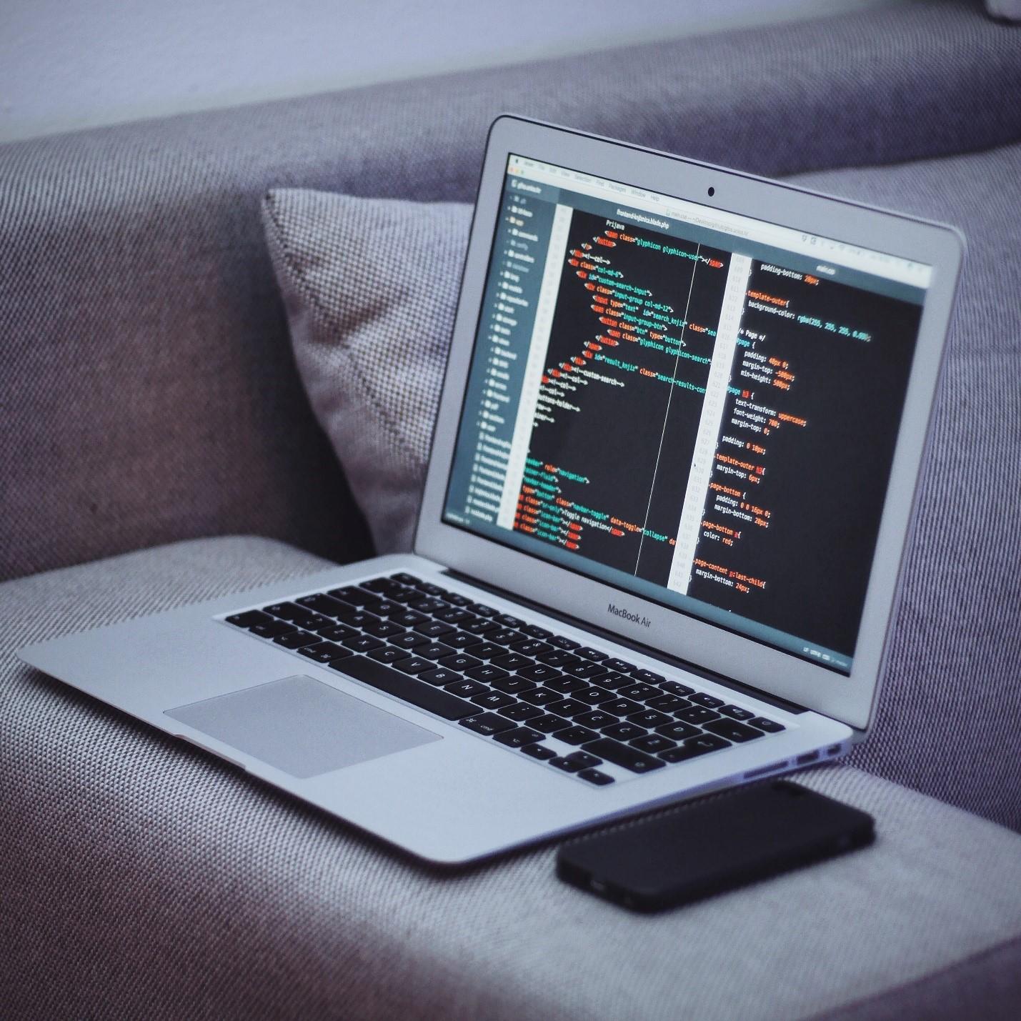 A MacBook displaying coding layout