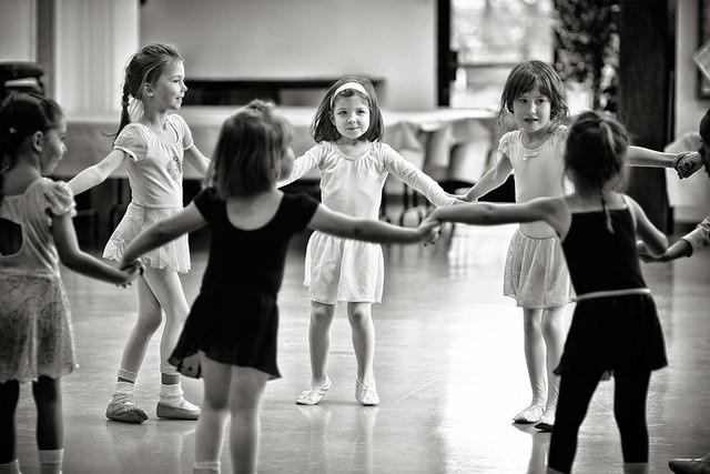 A group of children dancing together and taking hip hop dance lessons