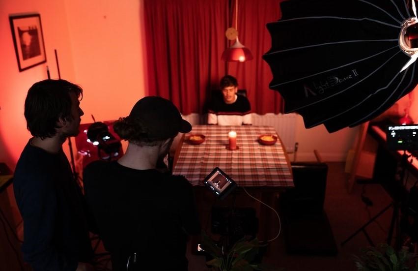 A man in black sitting on a chair