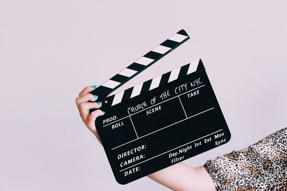 Woman holding a clapperboard