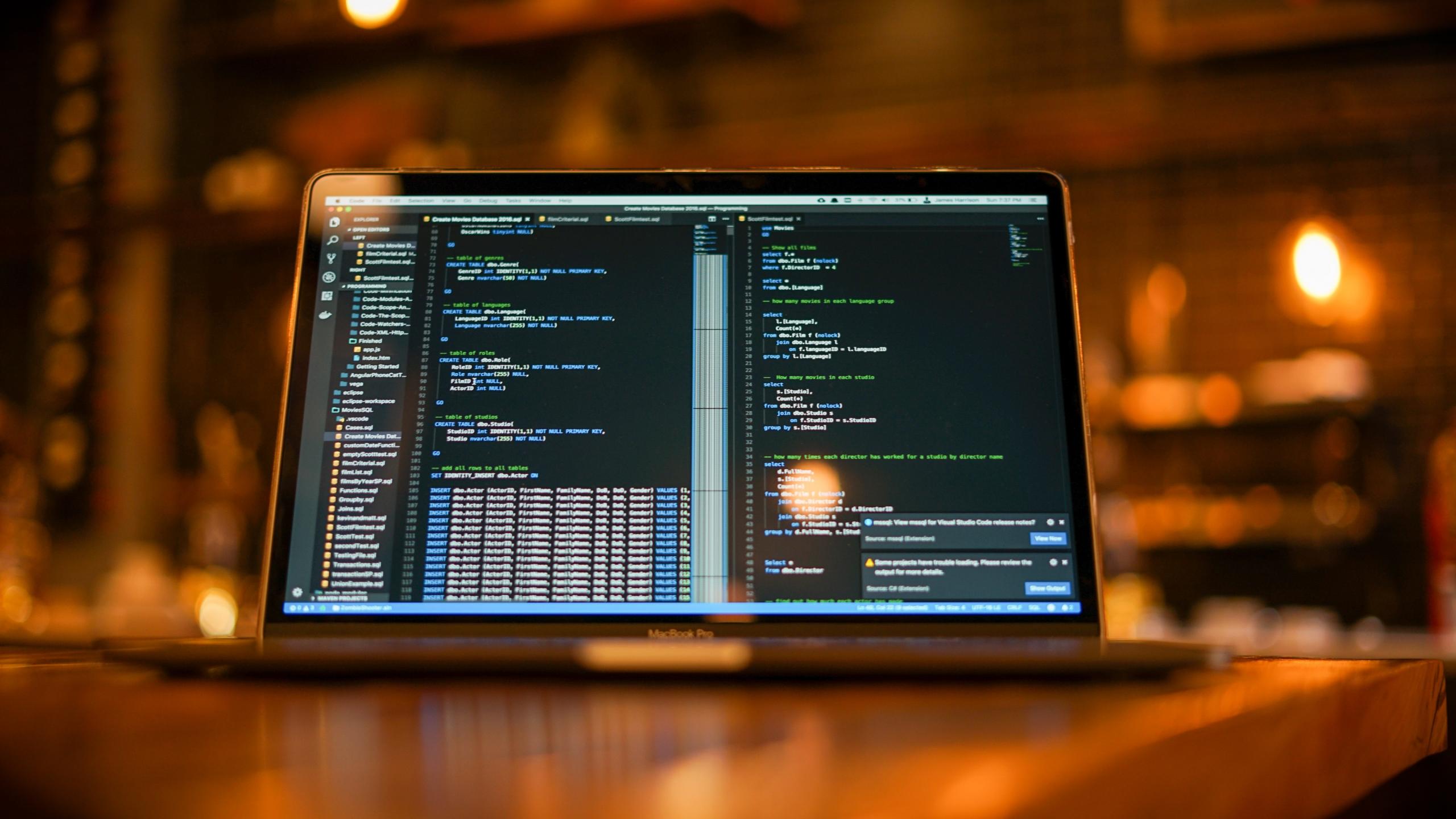 A MacBook displaying code