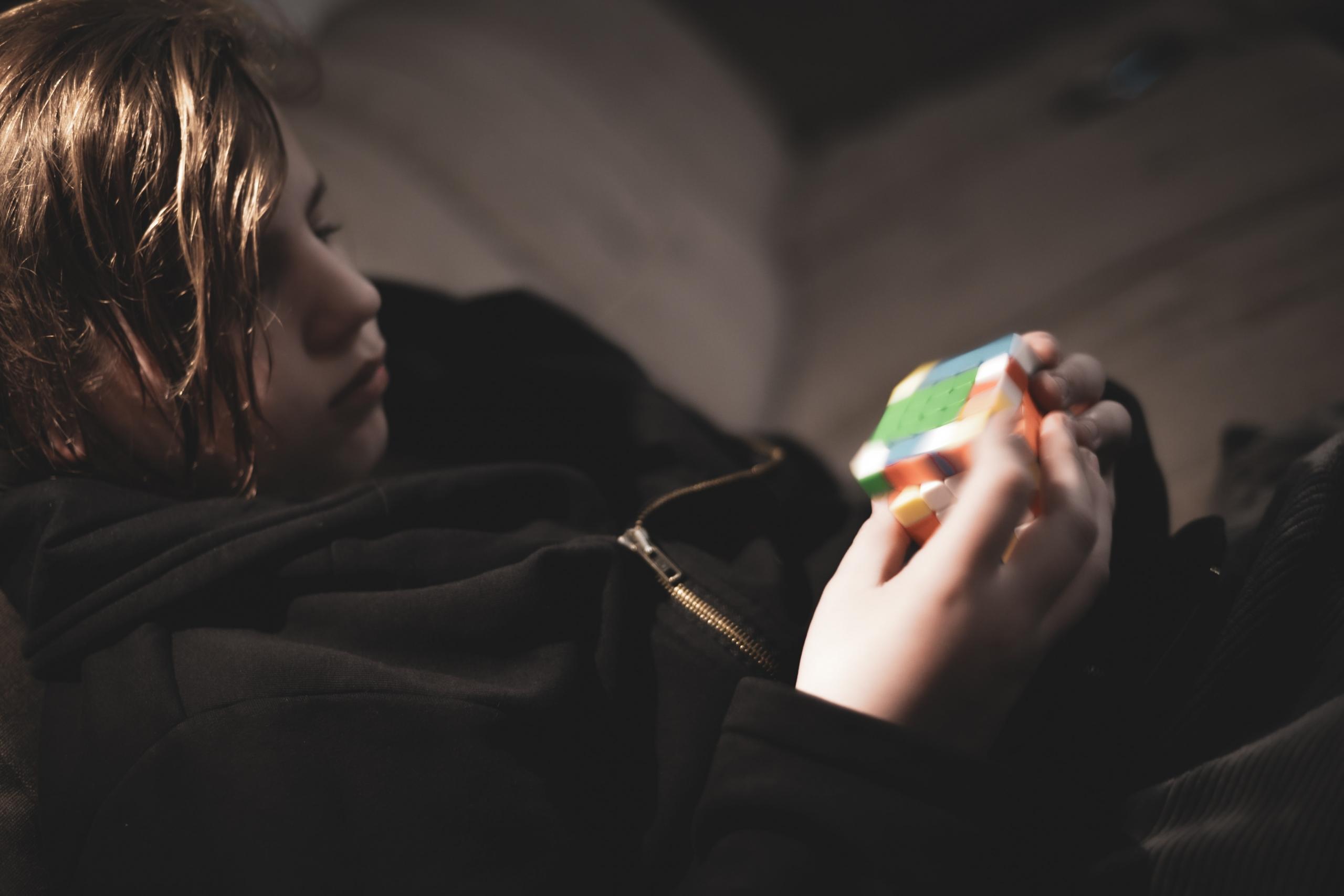 Kid learning to solve a Rubik cube