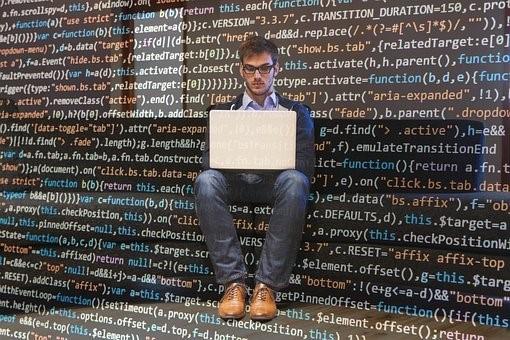 A computer programmer interpreting codes through programming languages