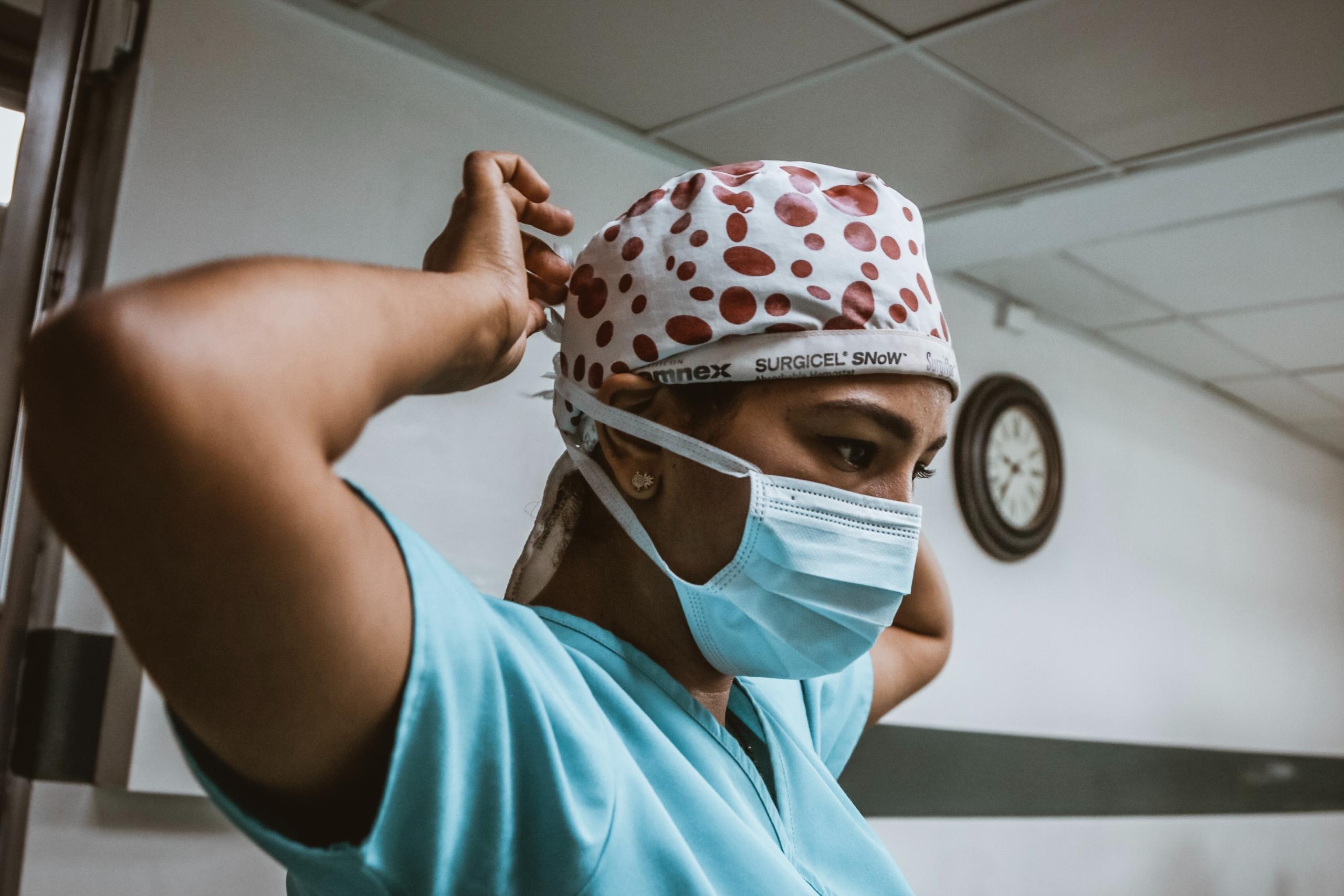 A Nurse Tying Her Surgical Cap