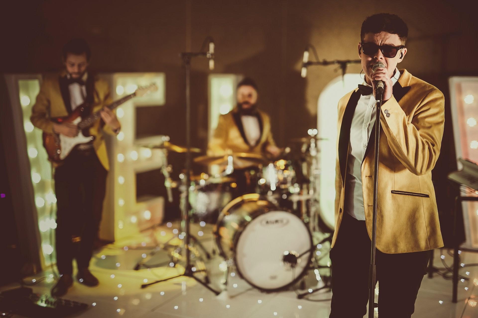 A soul band wearing gold tuxes.