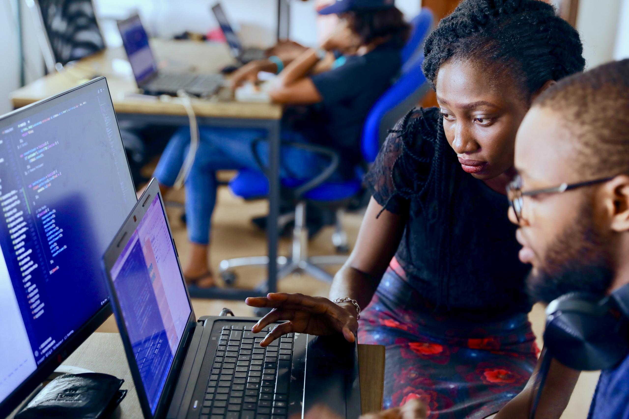 A tutor teaches coding to one of her students