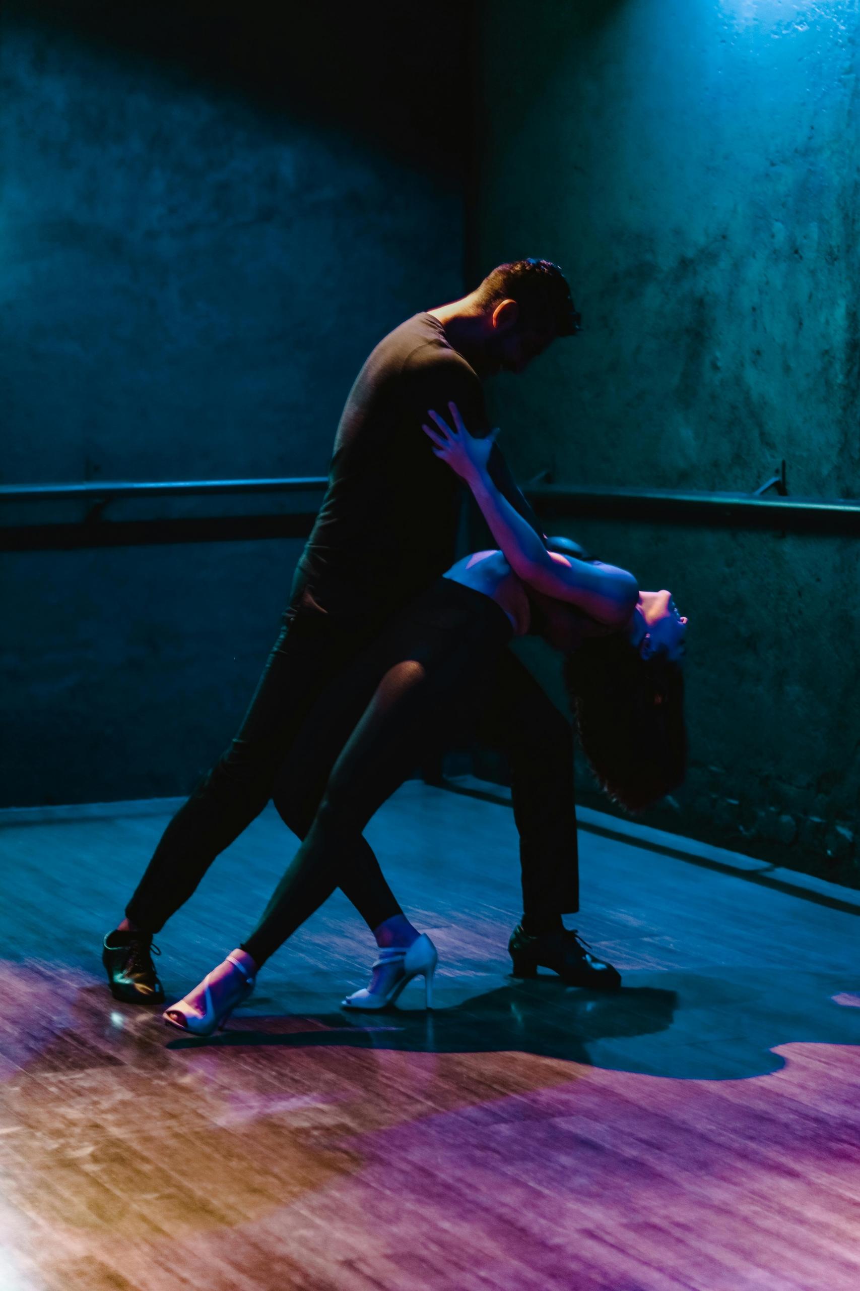 A couple showcasing their salsa dancing skills during a competition, with the woman performing an elegant turn.