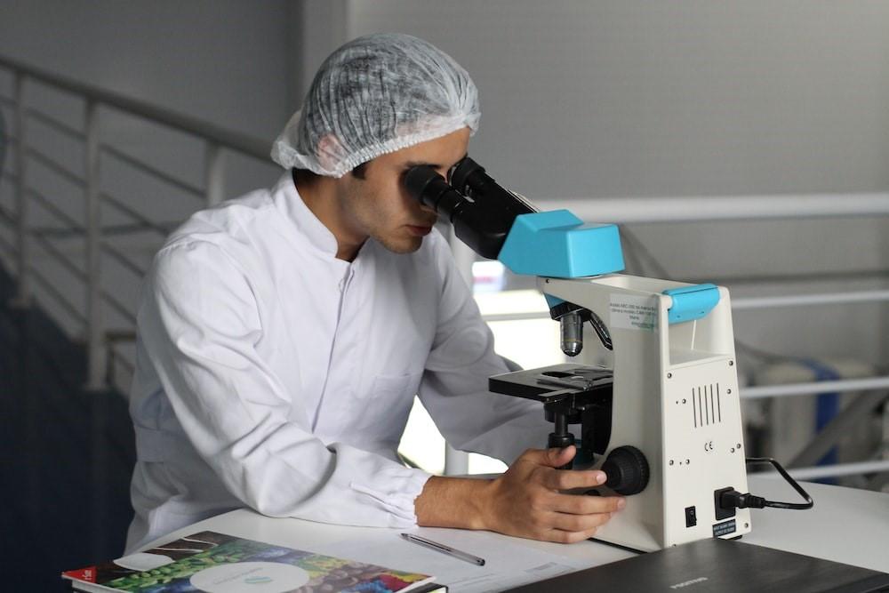 A man seeing the properties of compounds using a microscope