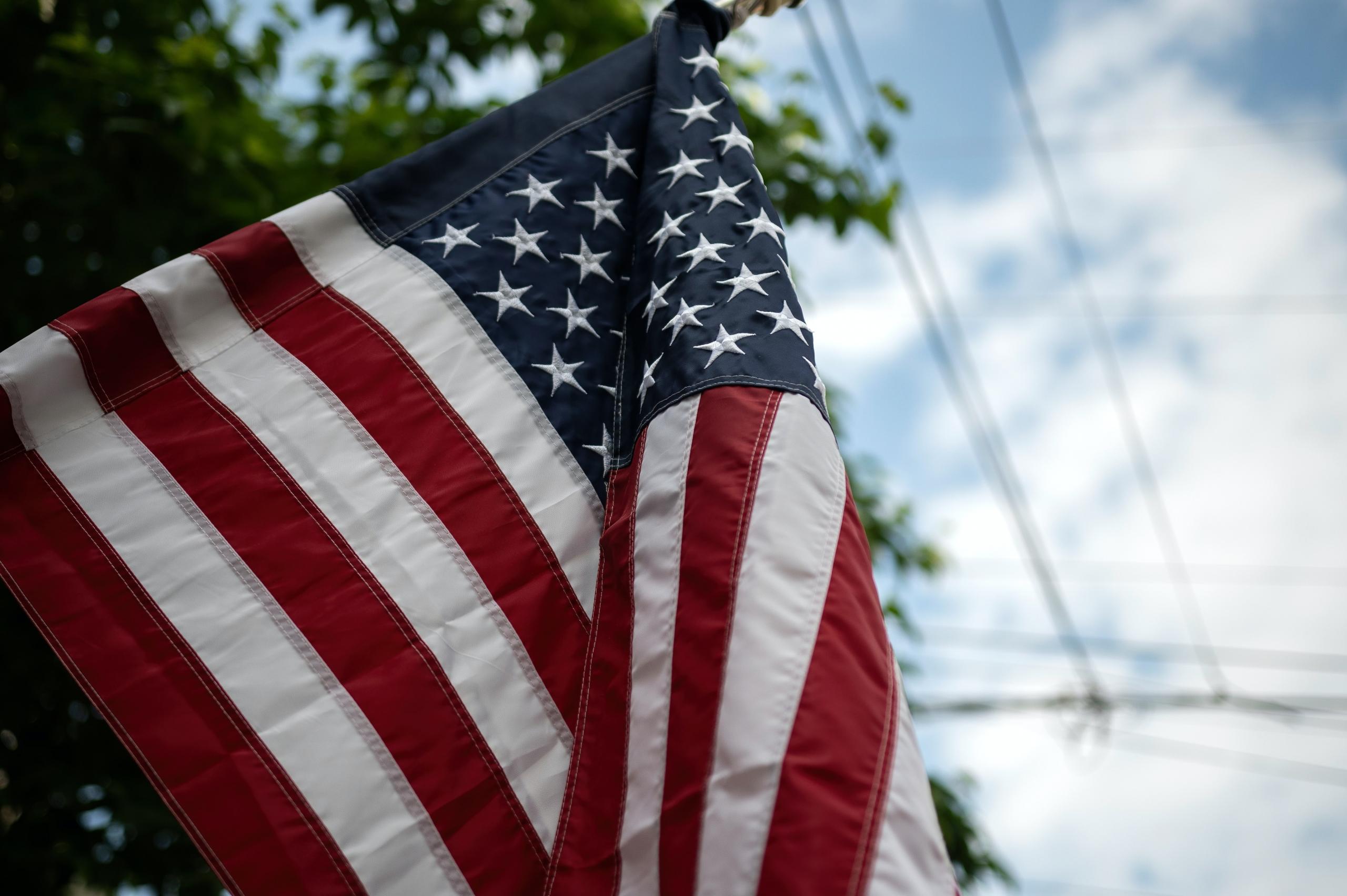 A US flag under a cloudy sky