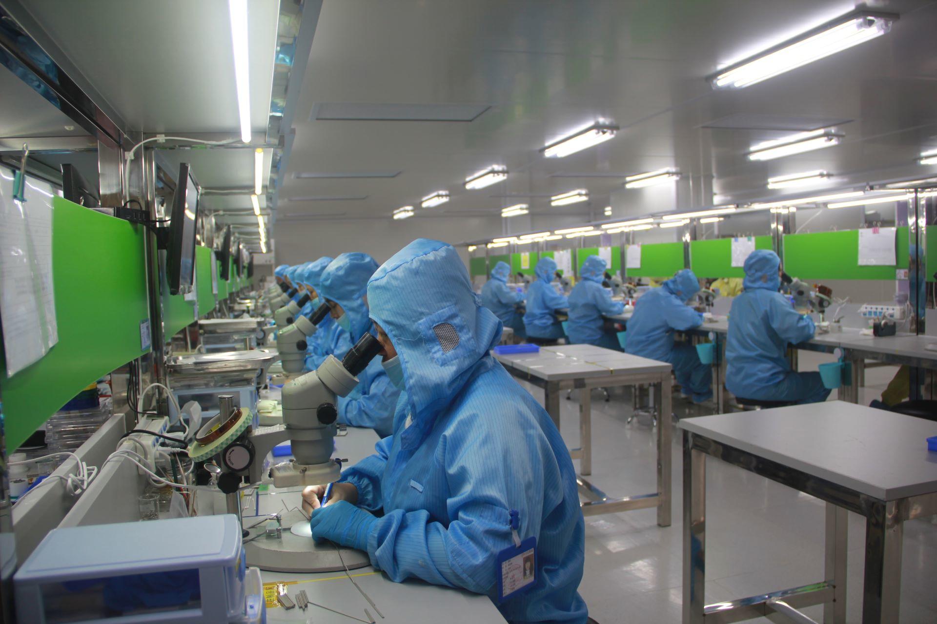 Analytic chemists working in a factory