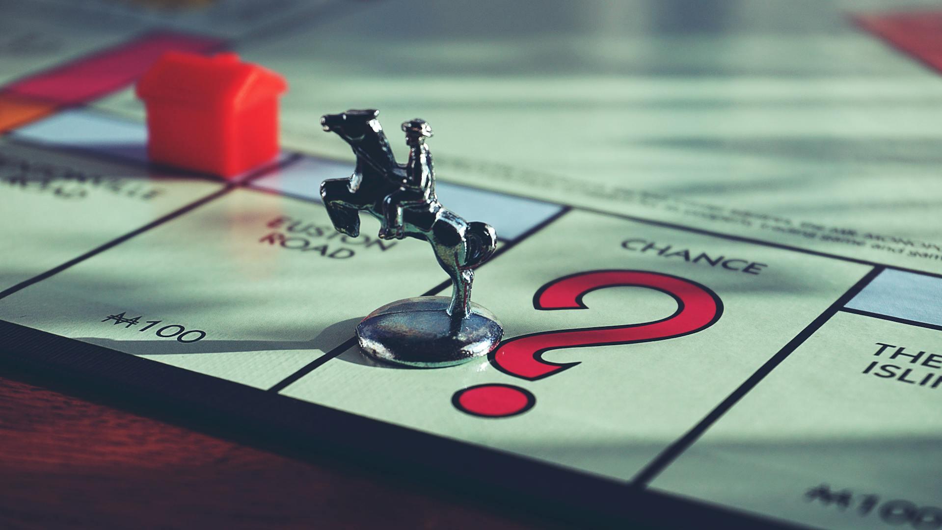 photo of a Monopoly game piece on the Monopoly board