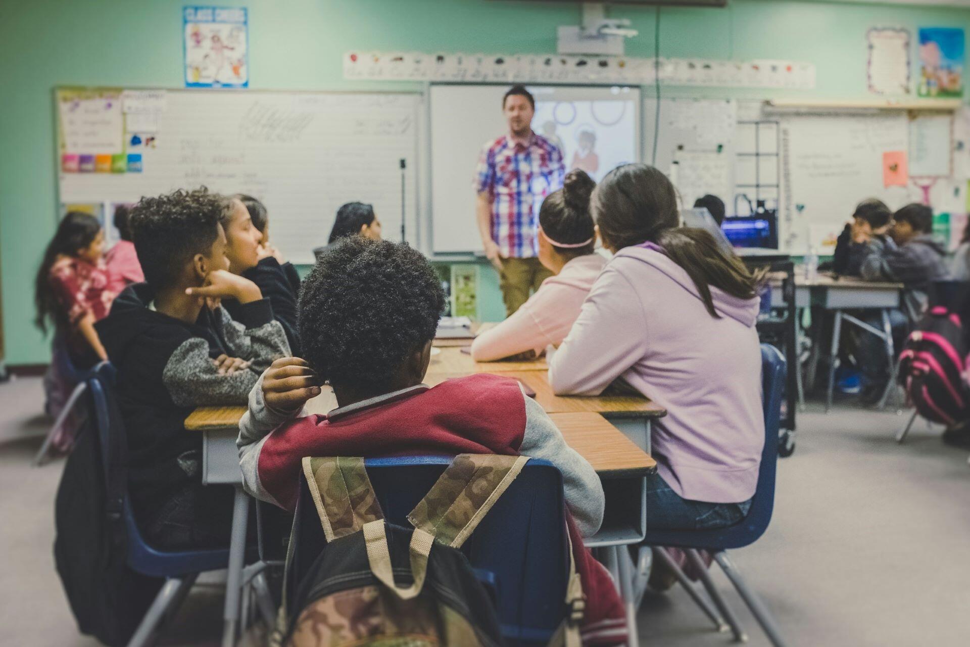 Students listening to a teacher in a high school classroom