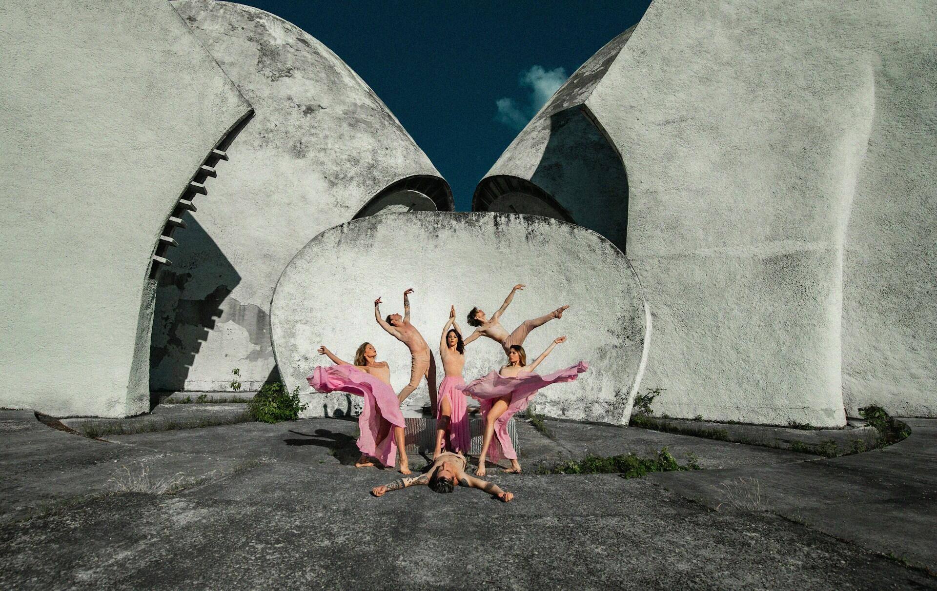 a group of dancers creates tension between one another through their poses