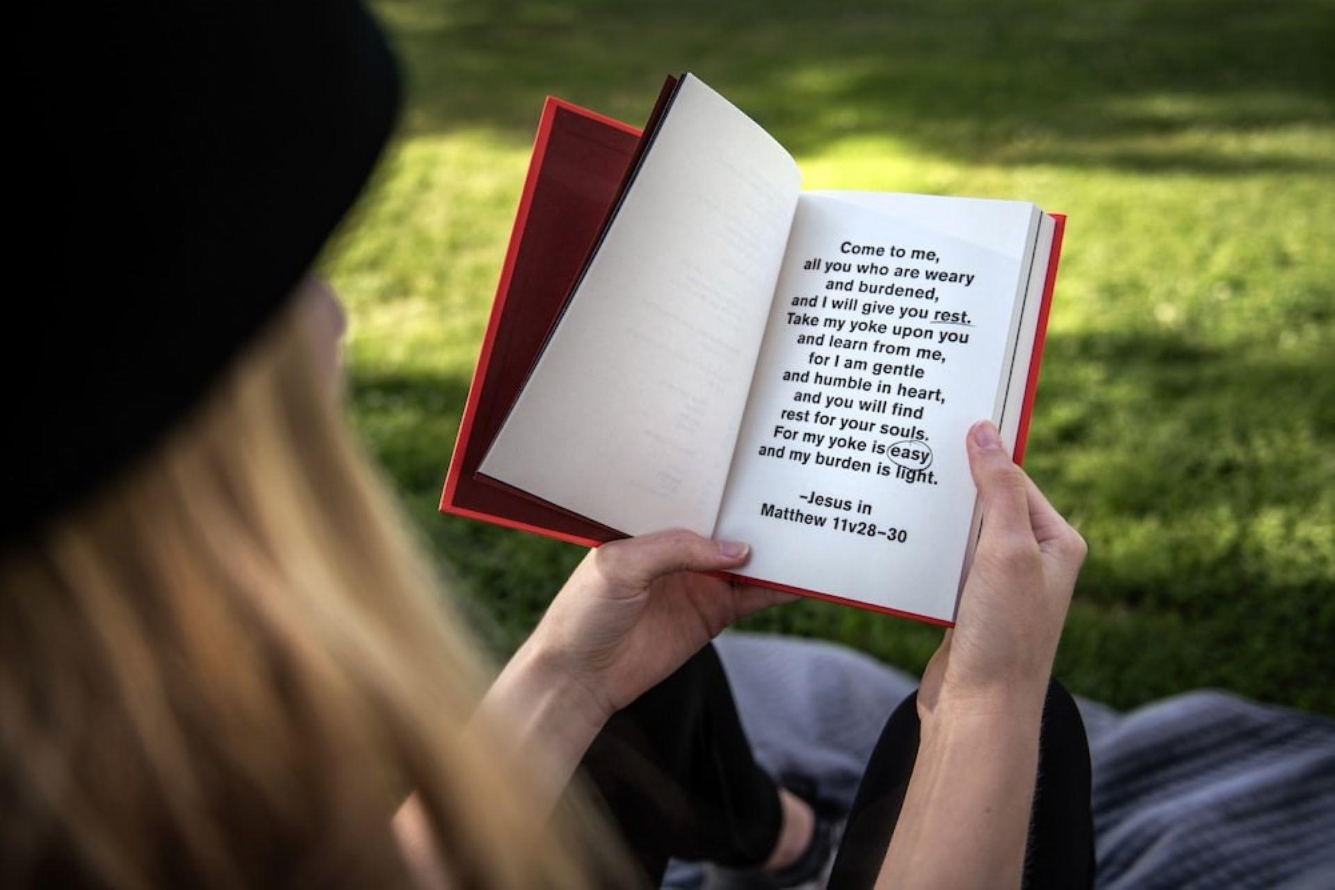 A girl reading a book in the garden