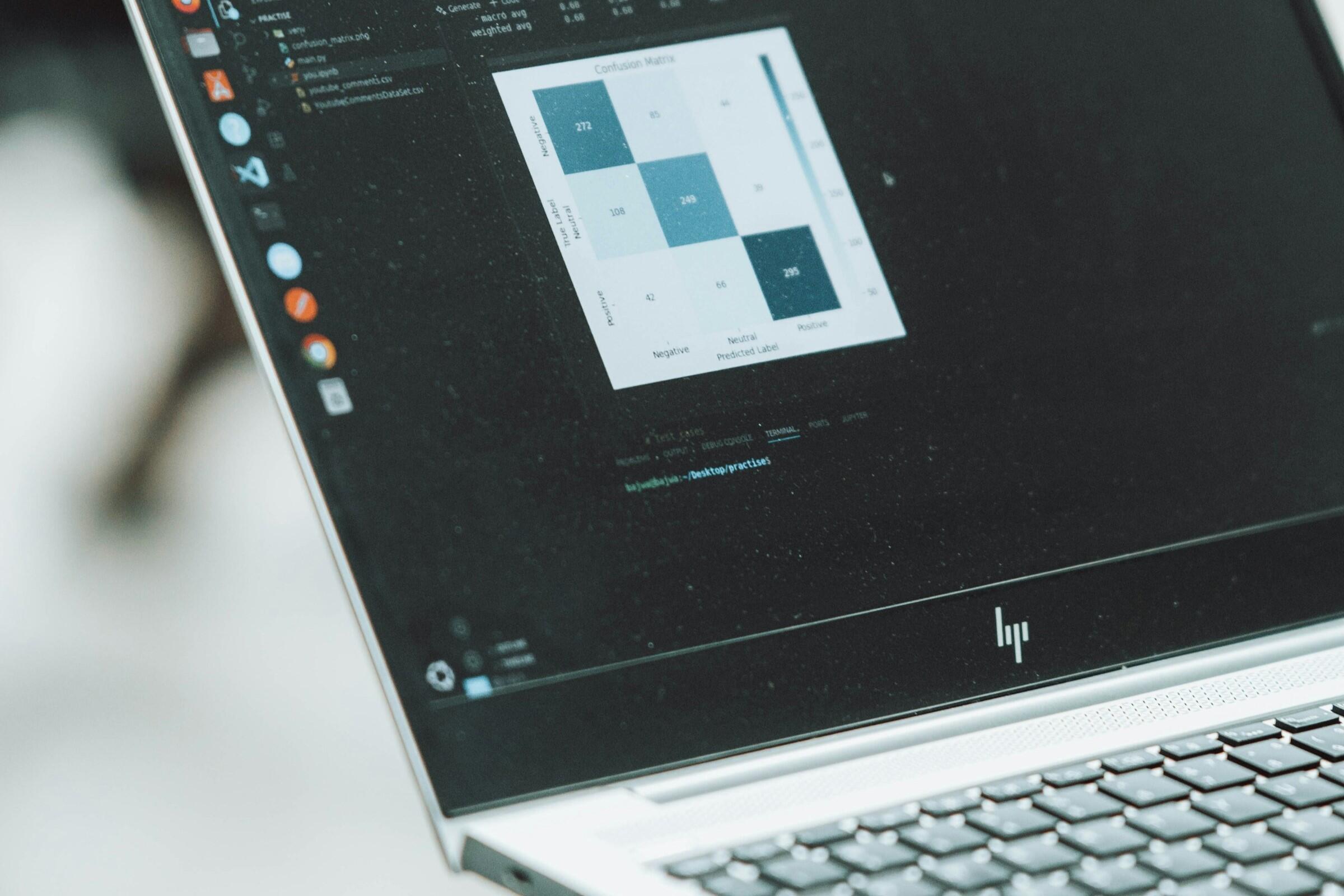 Laptop displaying statistical data analysis