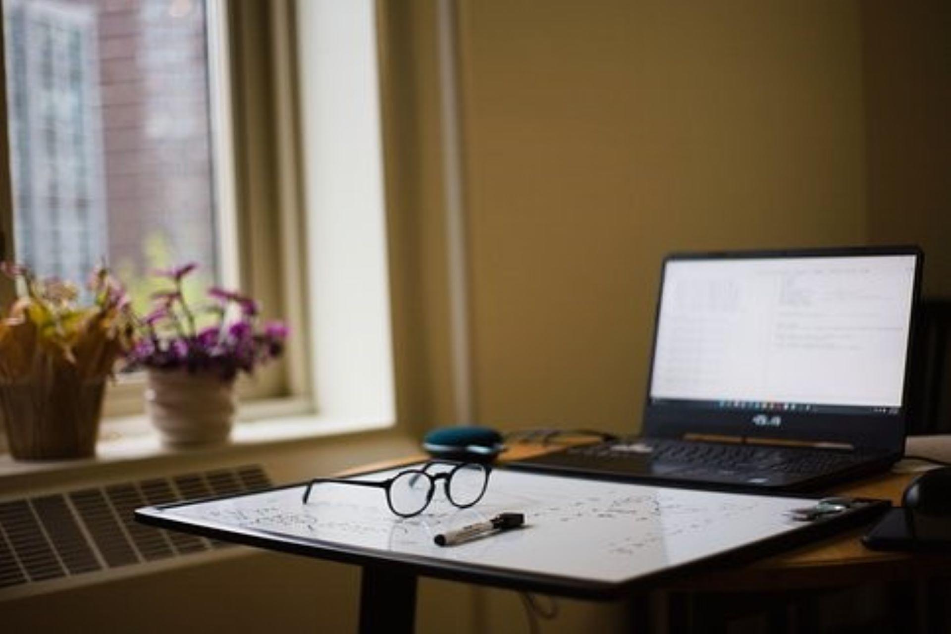 A laptop and notes on a desk