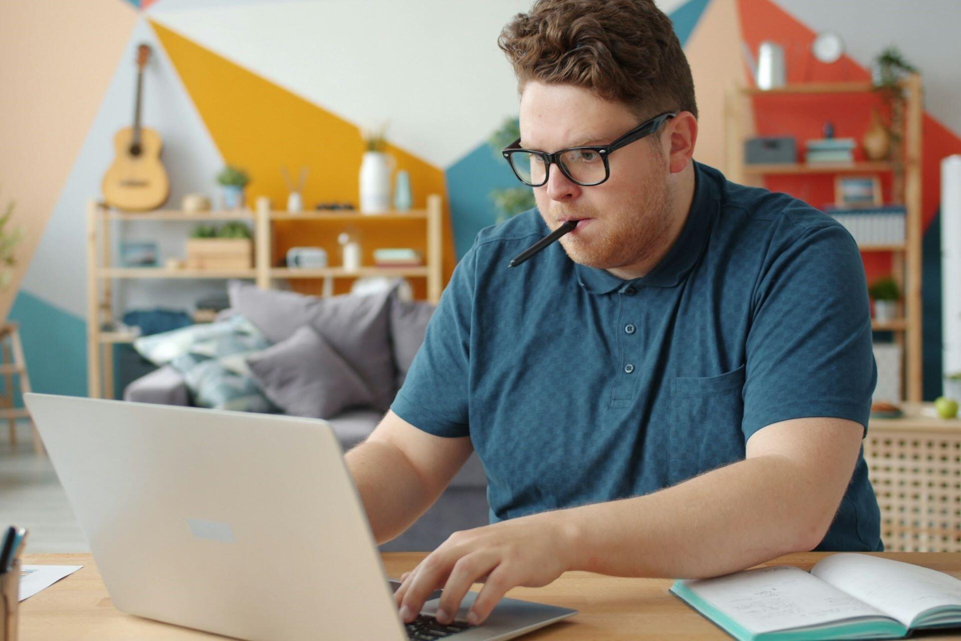 Student studying online with a laptop and notebook