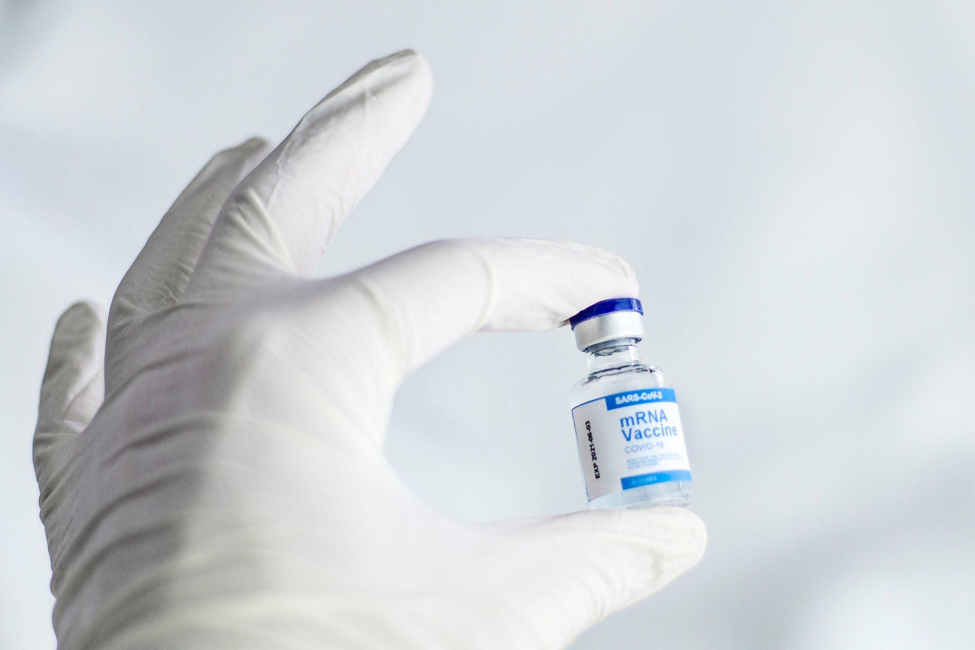 A pharmacist holding samples of vaccines