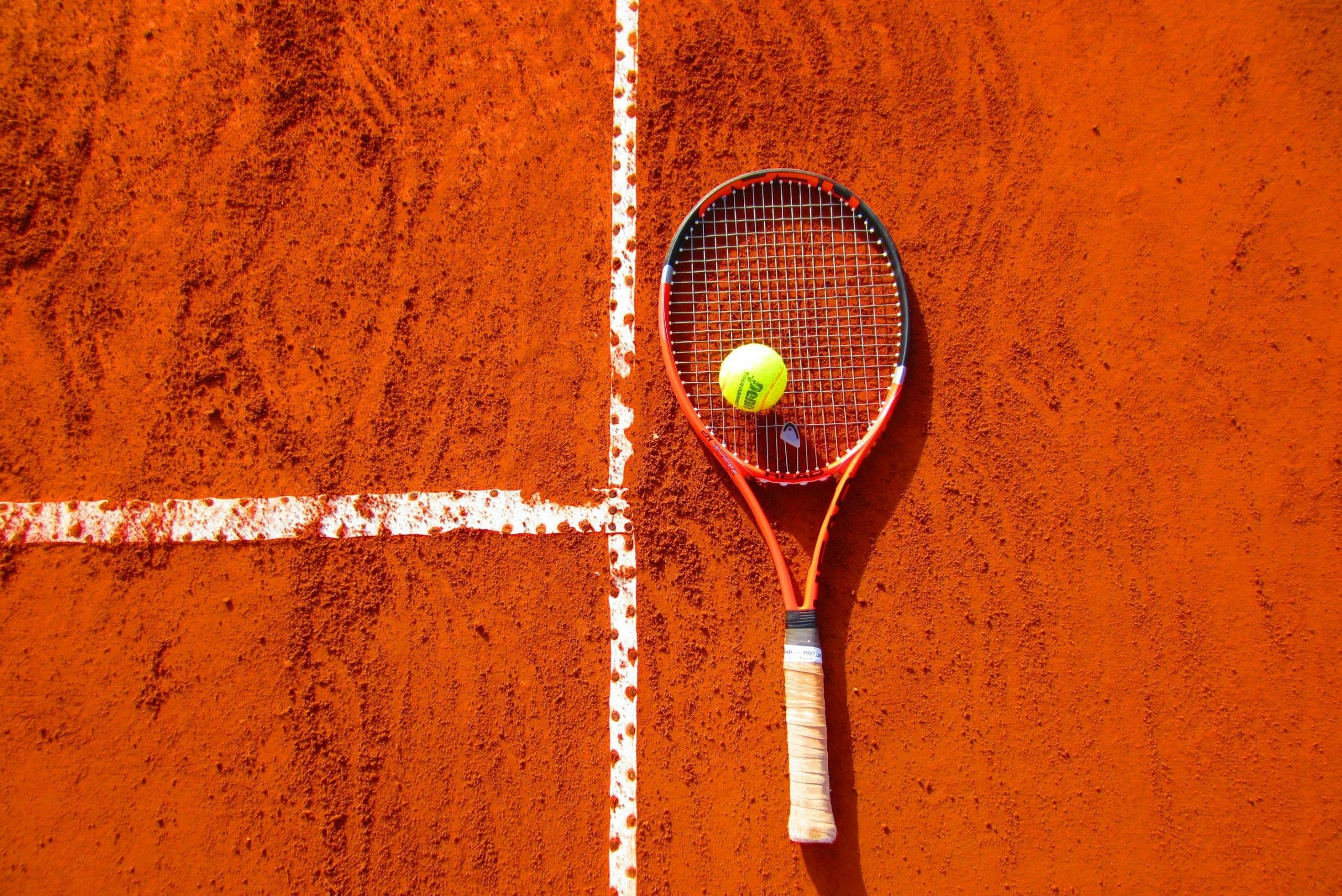 A clay court that is about to be used for a competitive tennis match.