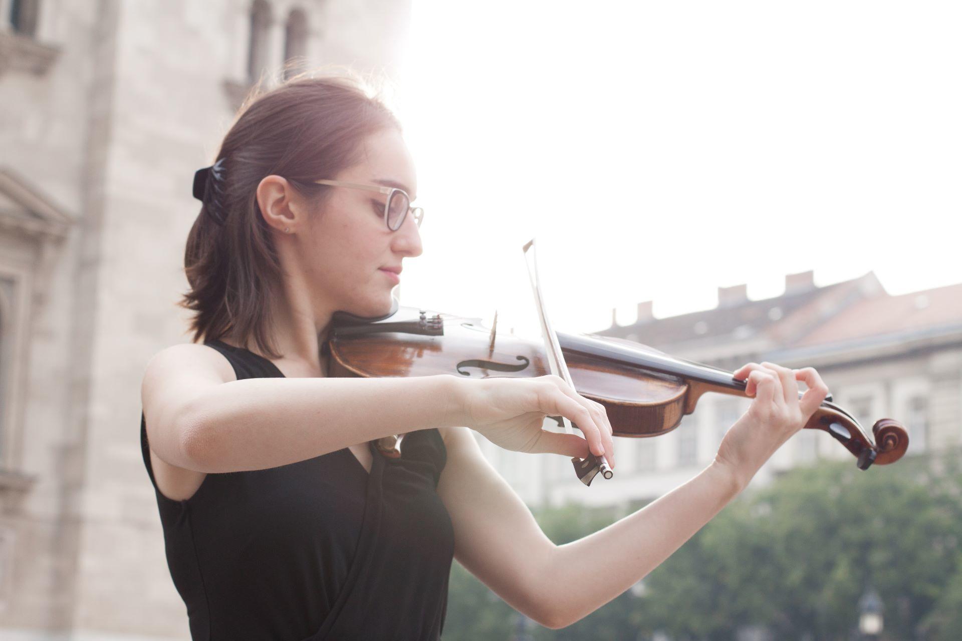 A young musician testing the violin