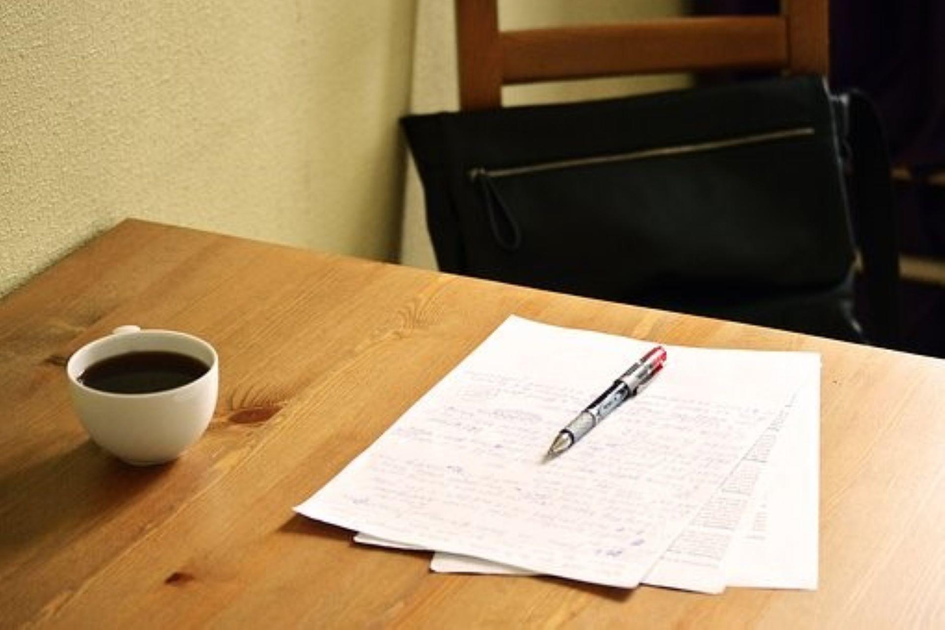 An English exam paper next to a cup of coffee