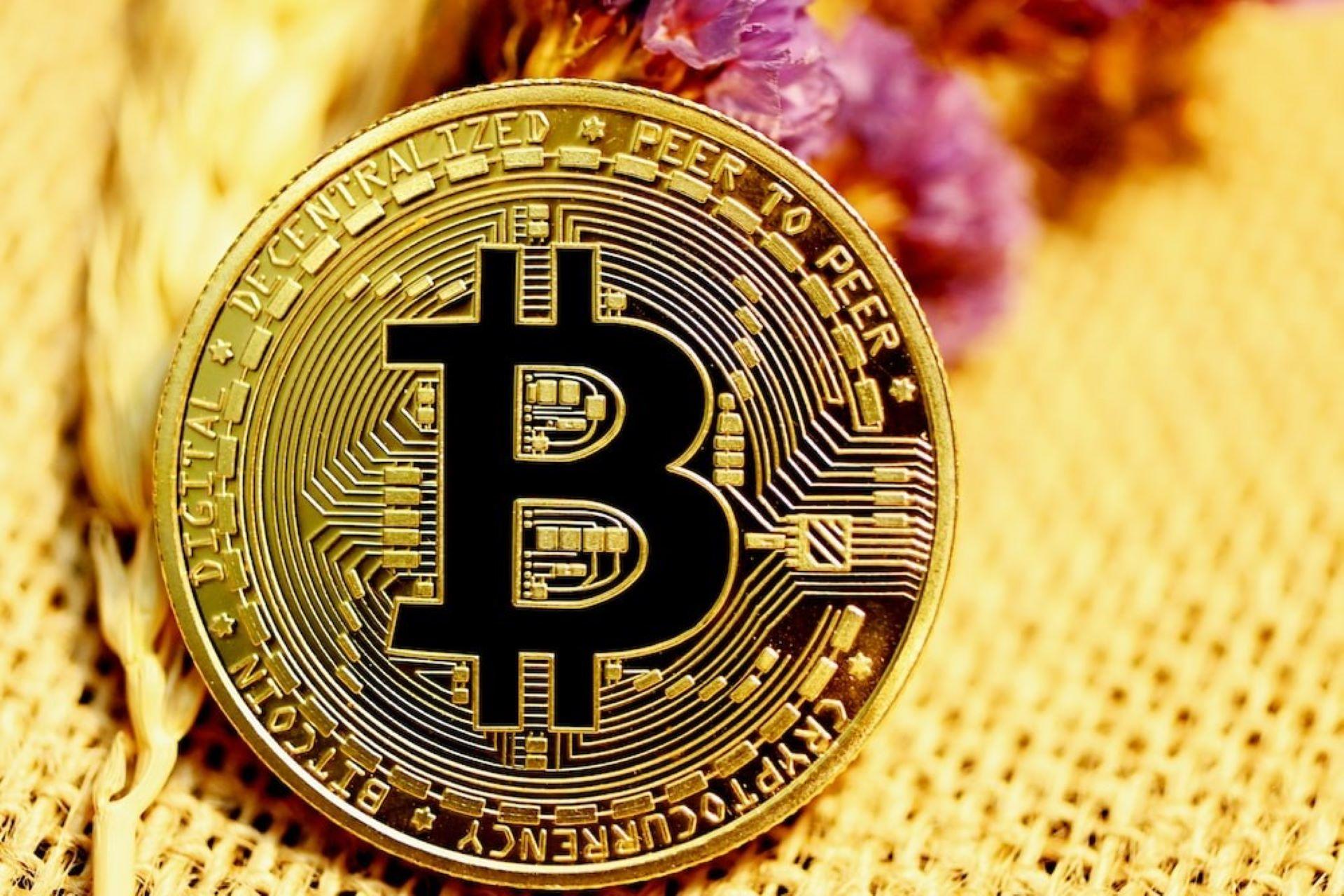 A gold-plated Bitcoin placed on a net