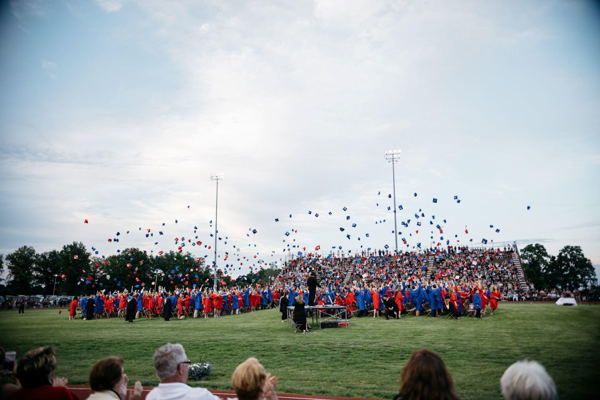 A high school graduation ceremony on a football field