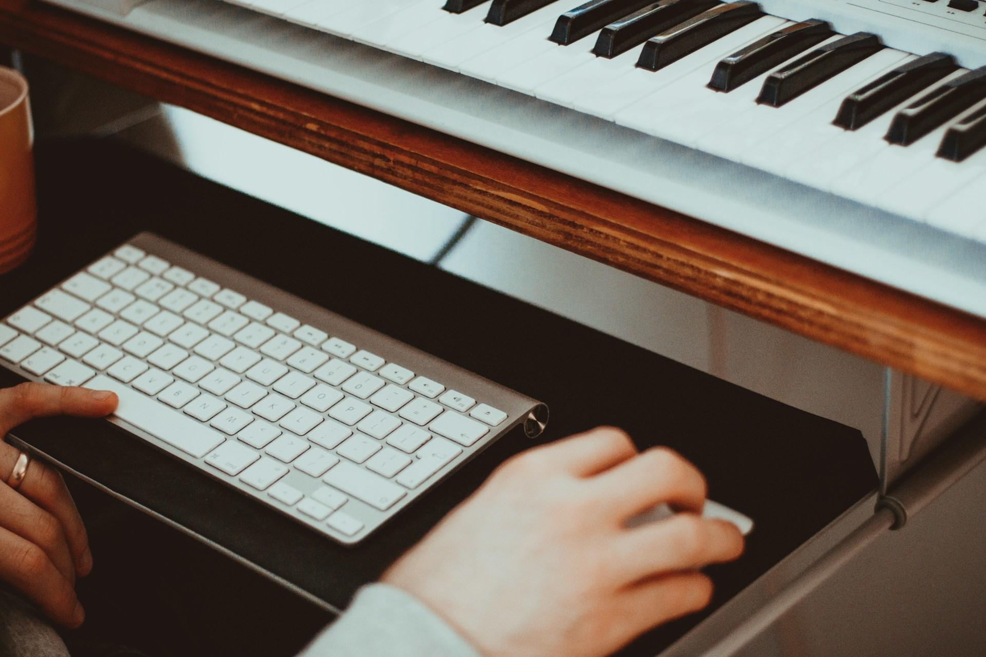A person with a keyboard and a piano.
